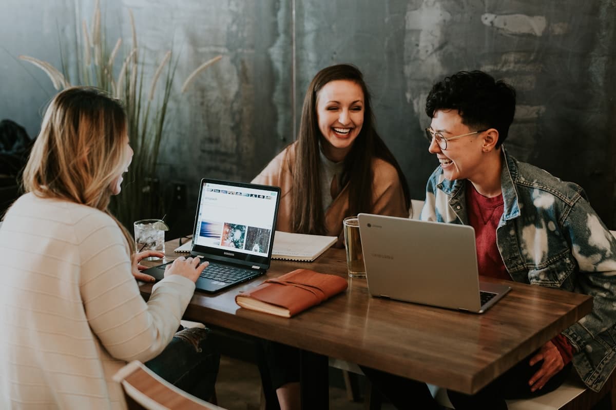 A team of developers collaborating around laptops on a website build
