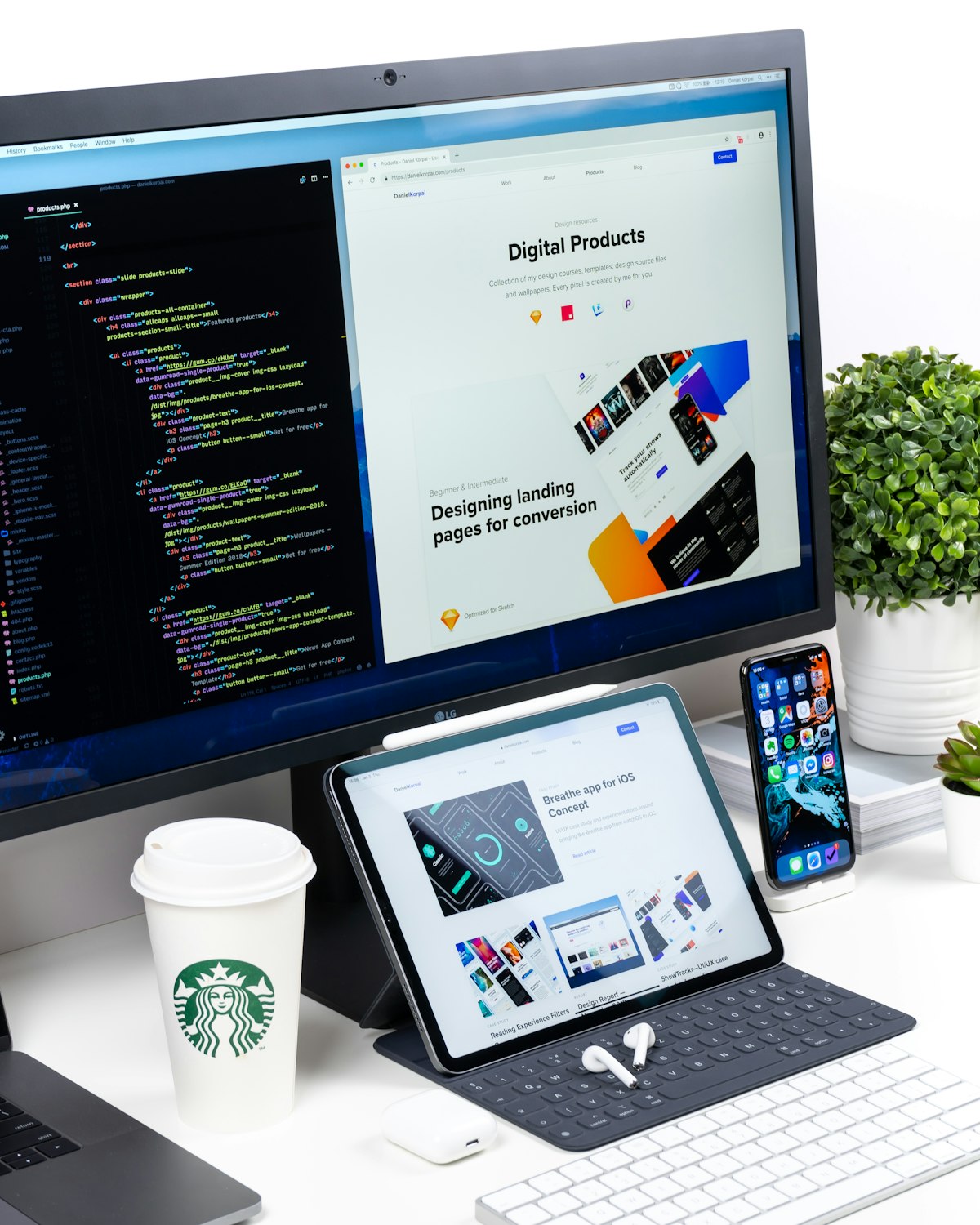 A desk with a computer screen showing code and a web design mockup side by side